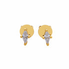 Gold earrings with clear gemstones on a light gray background
