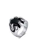 Silver ring with a black stone on a white background