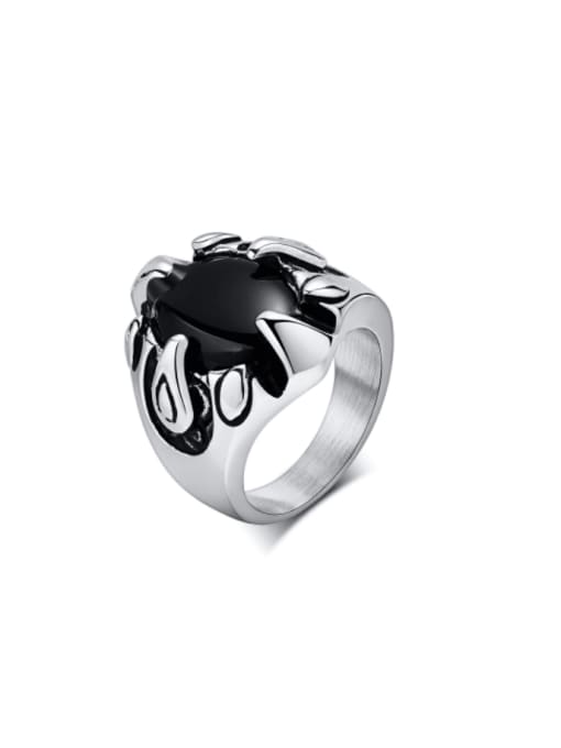 Silver ring with a black stone on a white background