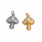 Gold and silver mushroom-shaped charms on a light gray background