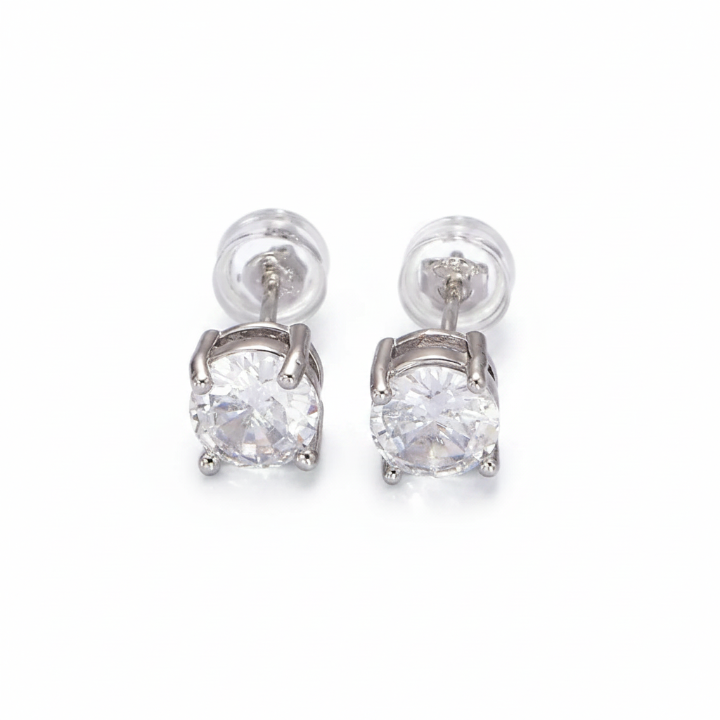 Pair of silver earrings with clear gemstones on a light gray background