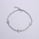 Silver bracelet with heart-shaped charms on a light gray background