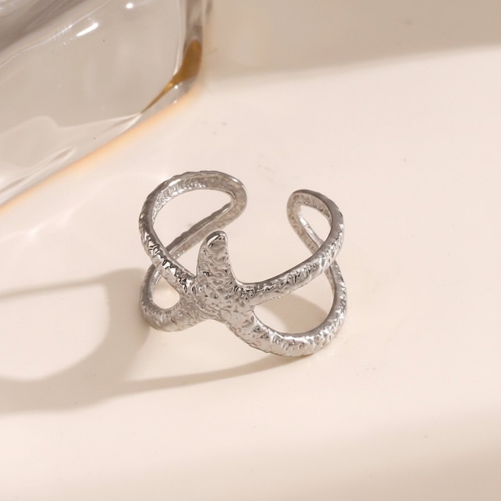Silver ring with a textured design on a light background