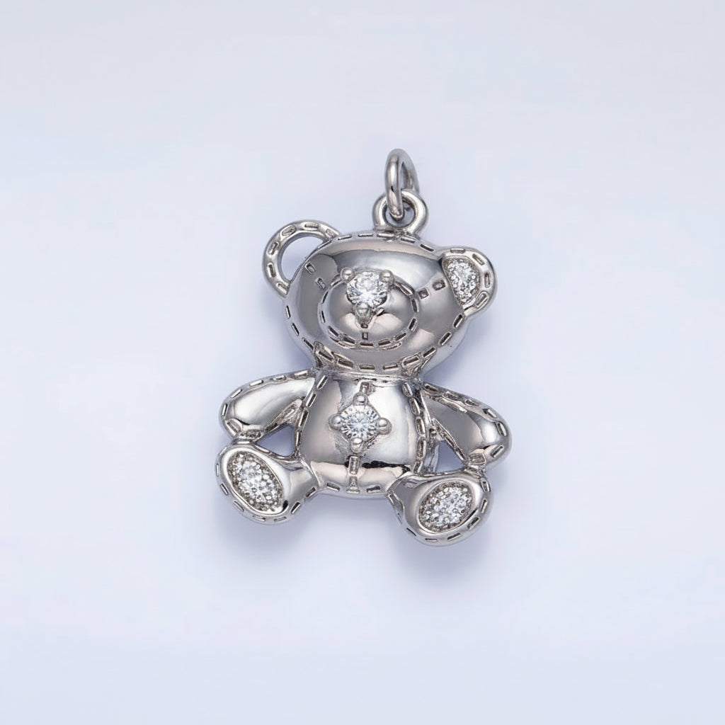 Silver teddy bear pendant on a light gray background