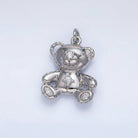 Silver teddy bear pendant on a light gray background
