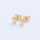 Gold mushroom-shaped earrings on a light gray background