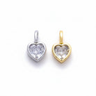 Two heart-shaped crystal pendants, one in silver-tone metal and one in gold-tone metal, displayed side-by-side on a clean white background.
