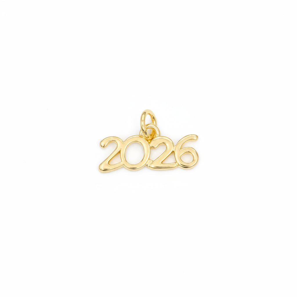 A gold charm spelling out the year '2026' in a cursive, openwork font, complete with a small hanging loop at the top, shown on a solid light blue background.