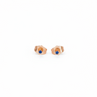 Pair of rose gold earrings with blue gemstones on a white background