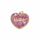 Heart-shaped charm with pink crystals and 'LOVE' engraving on a light gray background