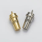 Two small coffee cup-shaped charms, one gold-toned and one silver-toned, both engraved with the word 'coffee' and shown on a plain light background.