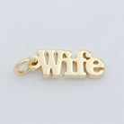 Gold 'Wife' charm on a light gray background